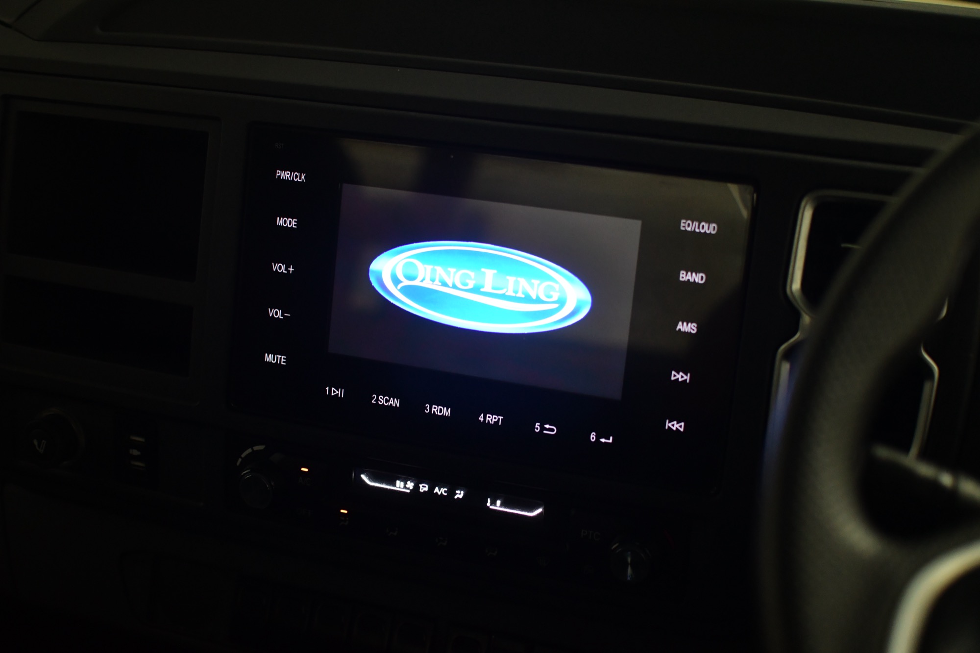 Centre touchscreen display showing the Qing Ling logo