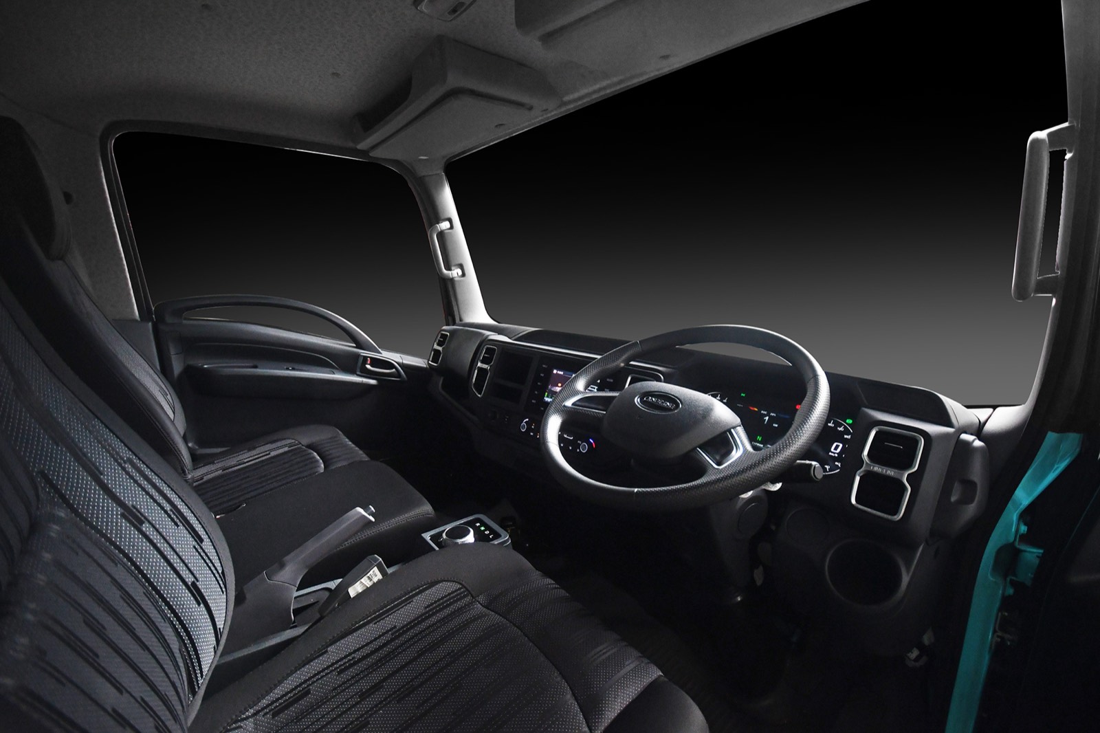 EQ2 cabin interior showing three-seater bench, steering wheel and rotary gear selector
